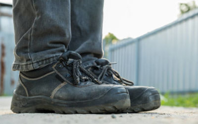 close up worker are wear safety shoes to prevent accidents at work.