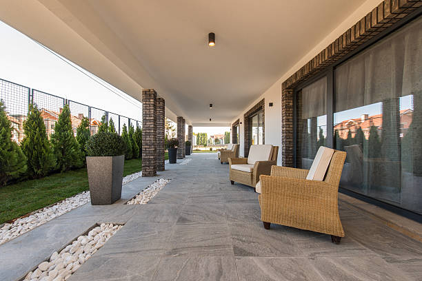 armchairs on open terrace in luxury villa exterior