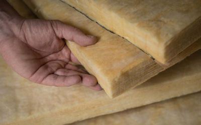 hand holding a fiberglass batt. image of home insulation.