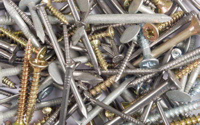 a pile containing all sorts of shiny screws and nails