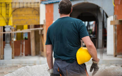 construction worker holding yellow hemlet